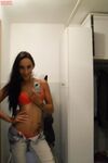 Teen with an inked body Ella Storm takes selfies while stripping in the mirror