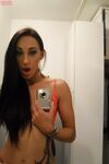 Teen with an inked body Ella Storm takes selfies while stripping in the mirror