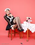 British pinup model uncovers her nice tits as she removes maid uniform