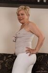 Charming granny Ursula Grande takes her top off and shows natural saggy tits
