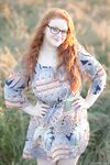 Hot redhead BBW Kaycee looses her huge tits and gets on her knees in a field