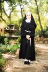 Thick Nun exposes herself in the courtyard wearing over the knee socks