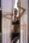 Blonde girl Chloe Toy drinks and smokes while modeling lingerie