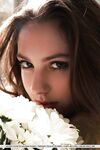 Sultry teen Valery Leche gets into a petal filled tub after removing lingerie