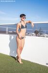 Amateur girl with short hair frees her pert tits from bikini top in sunglasses