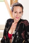 Mature housewife Genevieve Crest plays with her meaty labia lips