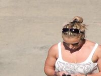 Oblivious busty Karmen Jay's big tits captured in downblouse voyeur photos
