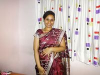 Clothed Indian woman strips to her black bra and underskirt