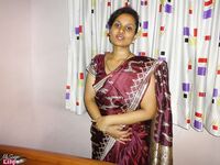 Clothed Indian woman strips to her black bra and underskirt