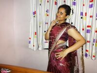Clothed Indian woman strips to her black bra and underskirt