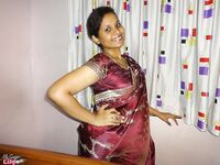 Clothed Indian woman strips to her black bra and underskirt