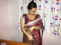Clothed Indian woman strips to her black bra and underskirt