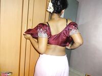 Clothed Indian woman strips to her black bra and underskirt