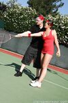 Sexy Penny Flame entices with ass & cleavage in tight dress on a tennis court
