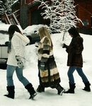 Three big boobed stunners pose braless in their fur coats in the snow