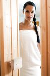 Tanned brunette Victoria Sweet oils herself in sauna and makes guy cum on face