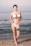 Sexy teen with tattoos Liya Silver gets fucked on a bed & poses on the beach