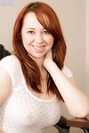 Busty redhead secretary Alisyn Carliene stripping her skirt and panties off