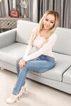 Superb blonde babe Bethany M doffs her jeans and exposes her perfect juggs