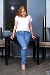 Hot redhead Samanta Simpson peels off ripped jeans on her way to posing naked