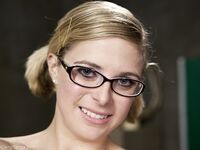 Nerdy pornstar Penny Pax shows her natural tits and poses in sheer pantyhose