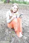 Long legged teen with a tight ass models naked on sand pit in woods