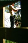 Hidden voyeur spies on naked girl getting dressed outdoors