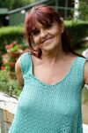 Redhead granny Livia lifts her blue dress up and reveals big natural tits