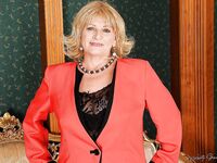 Curvy granny in stockings stripping off her suit and lingerie