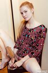 Natural redhead Bretona flashes a naked upskirt & squats nude with legs spread