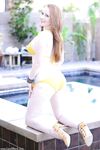 Solo model Lucy OHara toys her pussy by pool after removing her yellow bikini