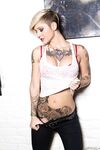 Tattooed model Kleio Valentien takes off clothes and boots to model naked