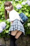 Cutie Japanese schoolgirl in pigtails shows naked ass in no panties upskirt