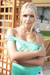 Sexy blonde chick Anette Dawn reveals her big tits as she disrobes