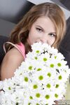 Cute teen Eveline frees her puffy pussy from panties with a daisy in her hair