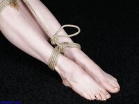 Naked blonde finds her nipples sticking out as she struggles against rope ties