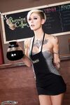 Gorgeous petite blonde barista poses on the cafe counter topless in boots