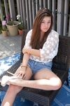 Shapely teen Nikki Yann bares round ass in thong panties & sheer shirt outside