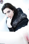 Pale girl with dark hair Nicotine fingers her naked pussy in a bathtub