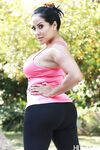 Latina MILF pornstar Kiara Mia revealing knockers while working out by pool