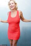 Mature blonde Molly MILF sets her large boobs free of red dress in solo action