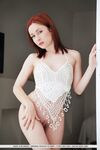 Pale redhead Night A in lace lingerie spreading long legs in bald twat closeup