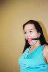 Ball gagged brunette is left all alone tied to a chair with ropes