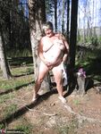 Fat granny Girdle Goddess loses her purple outfit in the woods and poses nude