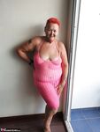 Fat nan with short red hair finger spreads her pussy on oceanside balcony
