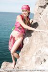 European teen Firebird A posing barefoot on rocky cliffs in revealing outfit