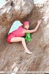 European teen Firebird A posing barefoot on rocky cliffs in revealing outfit