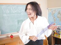 Naughty granny Nancy gets completely naked in the school room