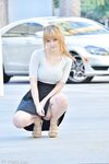 Cute young blonde flashes her big boobs and strolls naked down the street