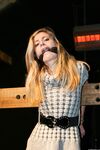 Cute blonde girl struggles against gag and ropes with her clothes still on